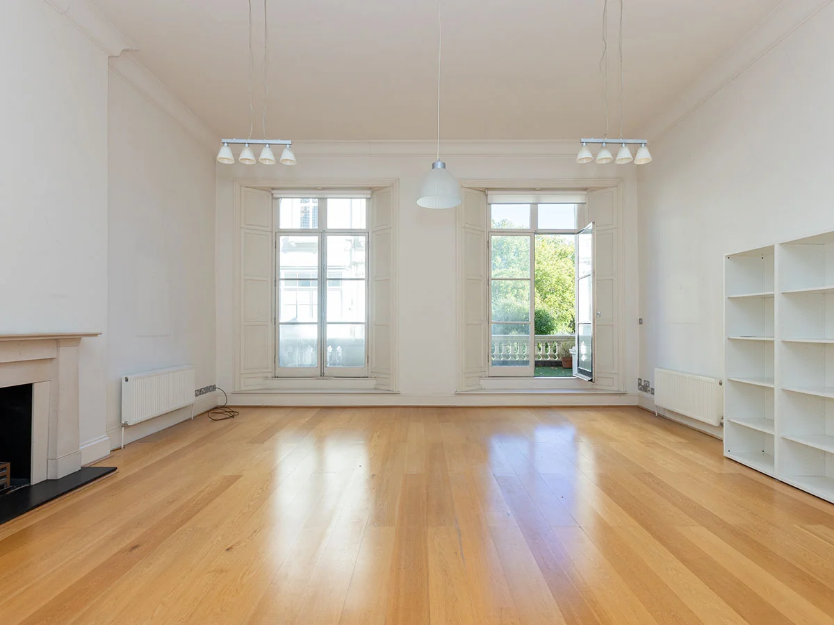 Before living room with wooden flooring, fireplace and large windows at Cleveland Gardens