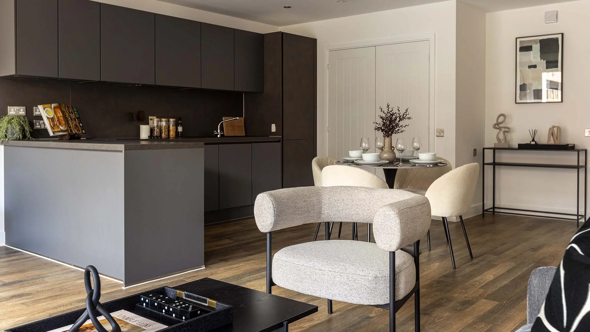 Beige accent chair in a modern open-plan kitchen and dining room