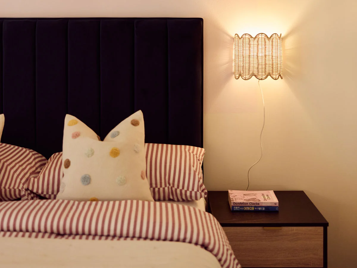 Saxon House two-bed interior with green headboard and patterned pillows by InStyle Direct