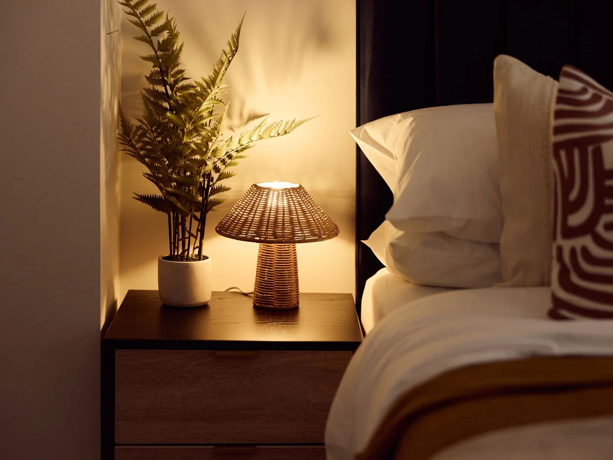 Saxon House two-bed interior with green headboard and patterned pillows by InStyle Direct