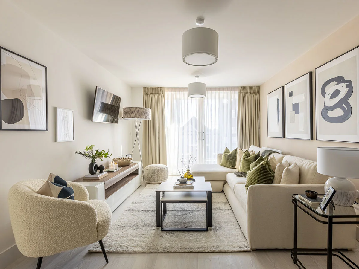 Neutral living room with cream sofa, armchair, green cushions and contemporary furniture in Watford