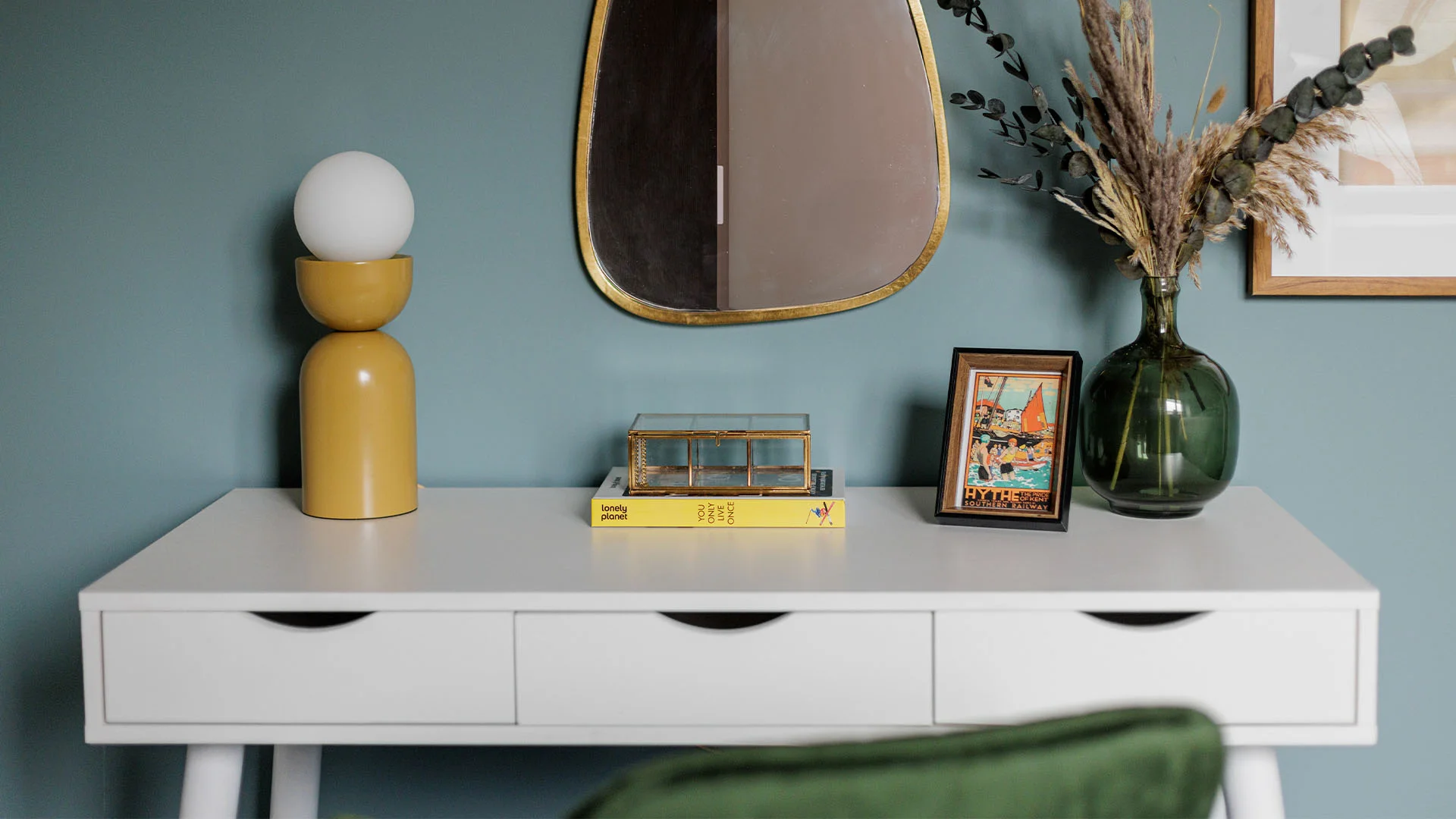 Modern console table styling with mirror and decor from gold furniture package in London apartment