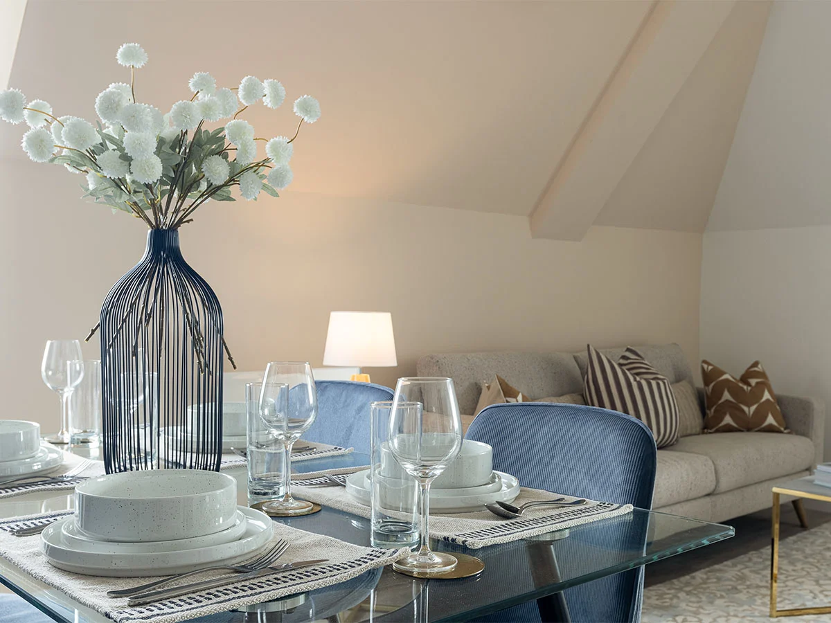 Open plan dining and living area styled with gold furniture package in modern apartment