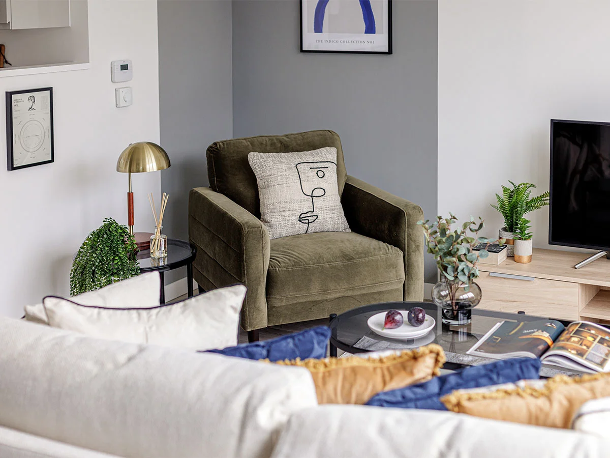 Modern living room with armchair and decor styled using gold furniture package