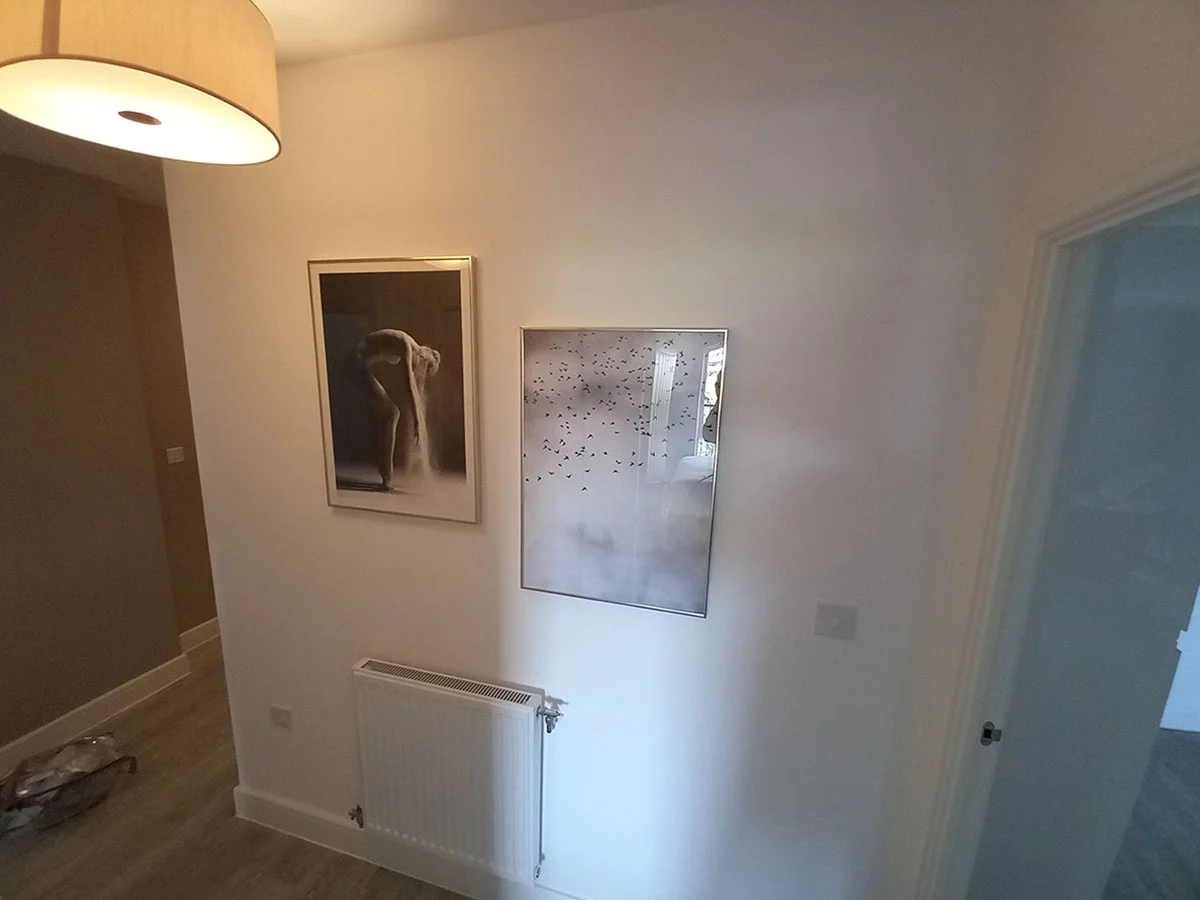Contemporary hallway with framed artwork and minimalist interior styling in a professionally furnished London apartment