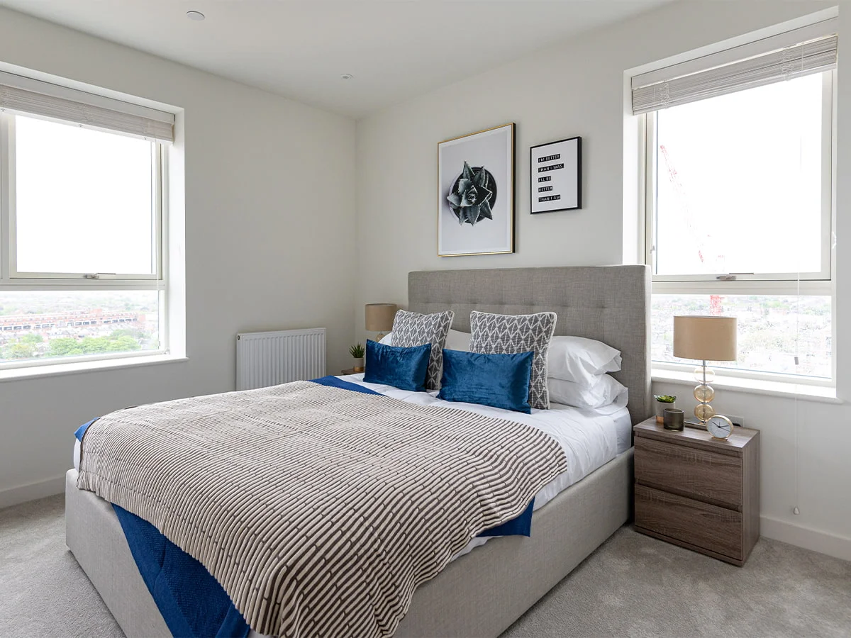  Minimal roller blinds in modern apartment bedroom with soft neutral décor