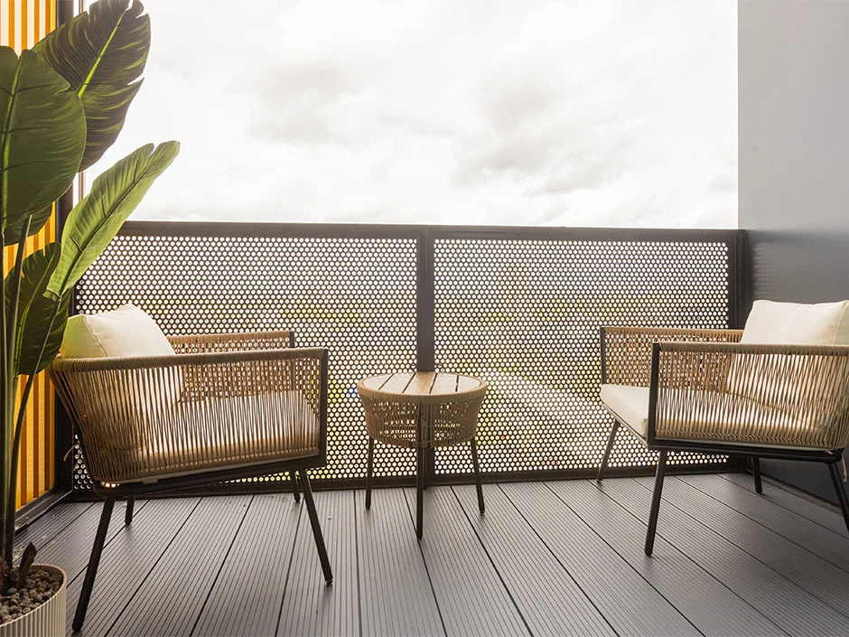 Modern outdoor balcony seating area with two woven lounge chairs and table