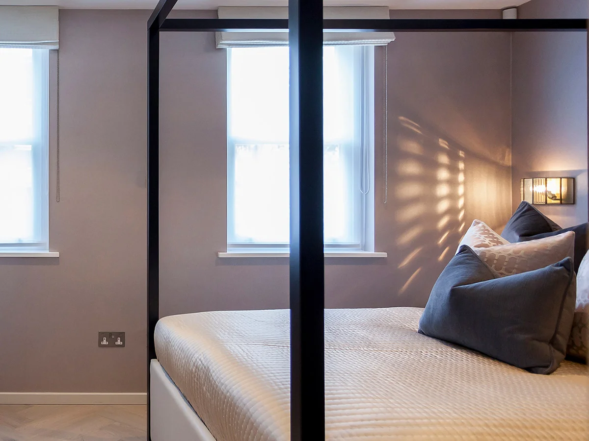 Simple roller blinds in modern bedroom with minimalist interior styling