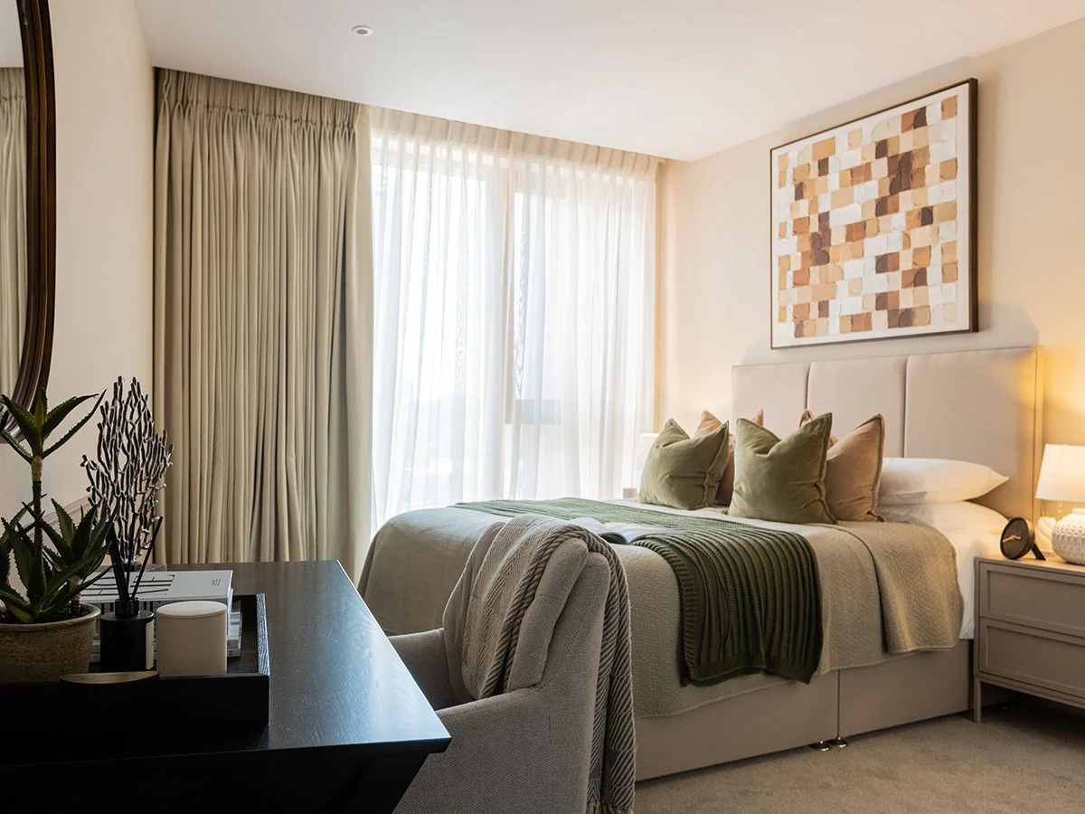 Elegant master bedroom with upholstered bed, soft furnishings, and floor-to-ceiling windows at West End Gate, London