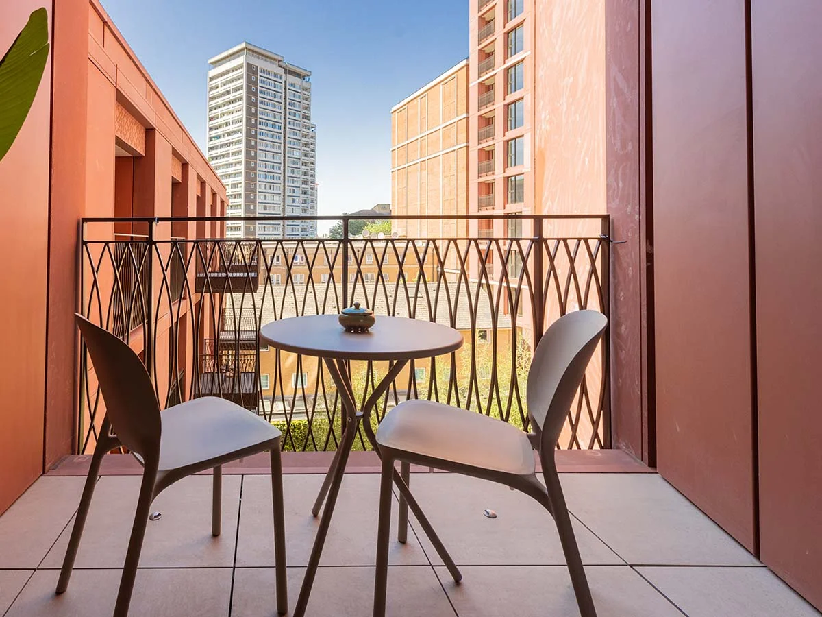 Private balcony with outdoor seating and views across the West End Gate residential development in London